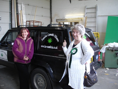 Lezley Gibson and Pat standing beside a Legalise Cannabis Alliance vehicle